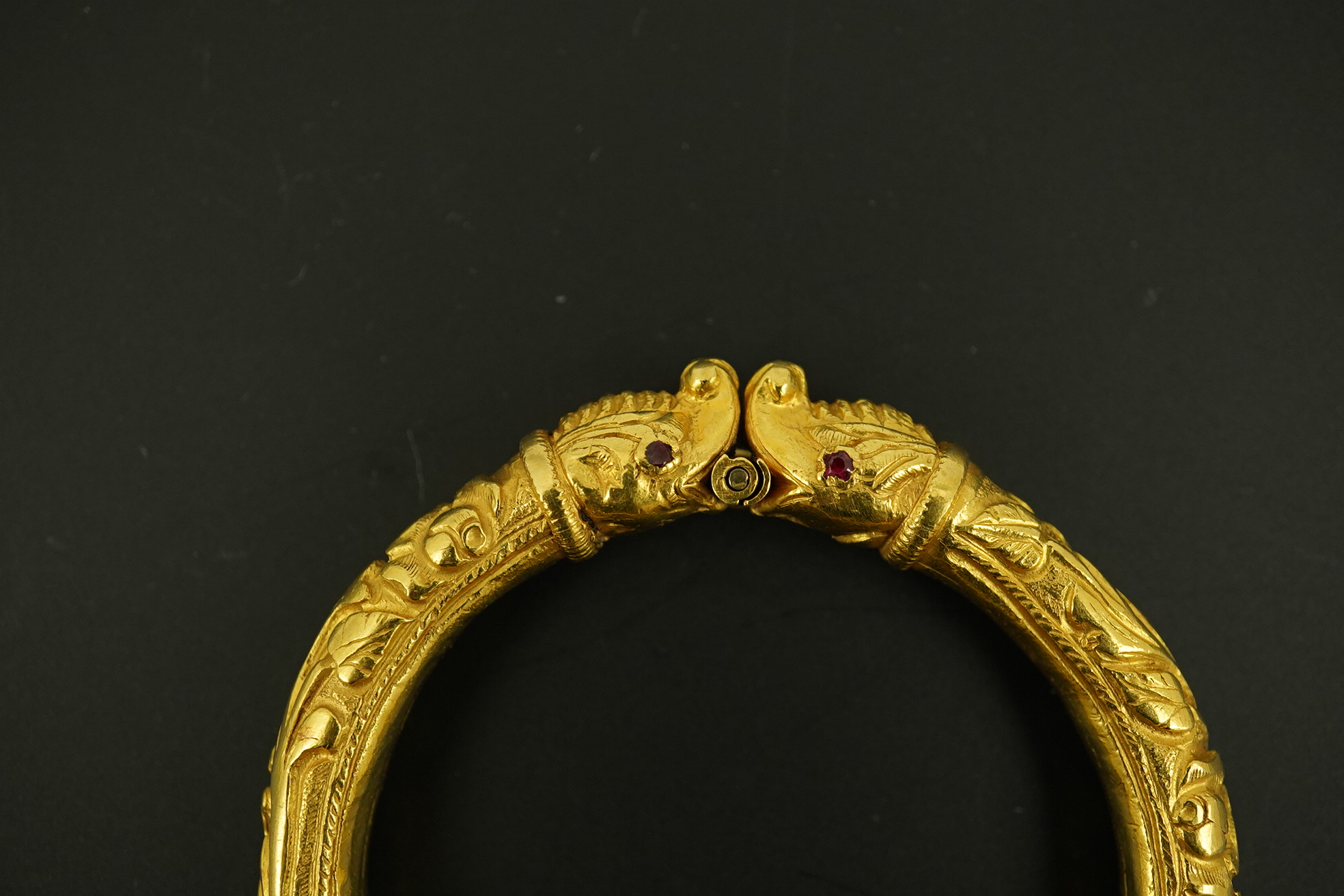 An antique Indian? high carat gold hinged bangle